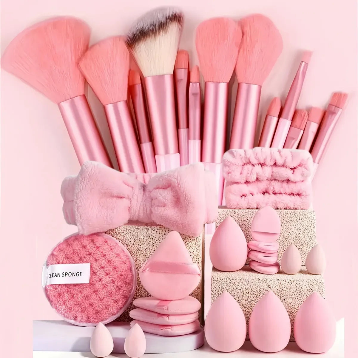 Pink makeup brush and beauty tool set with storage bag