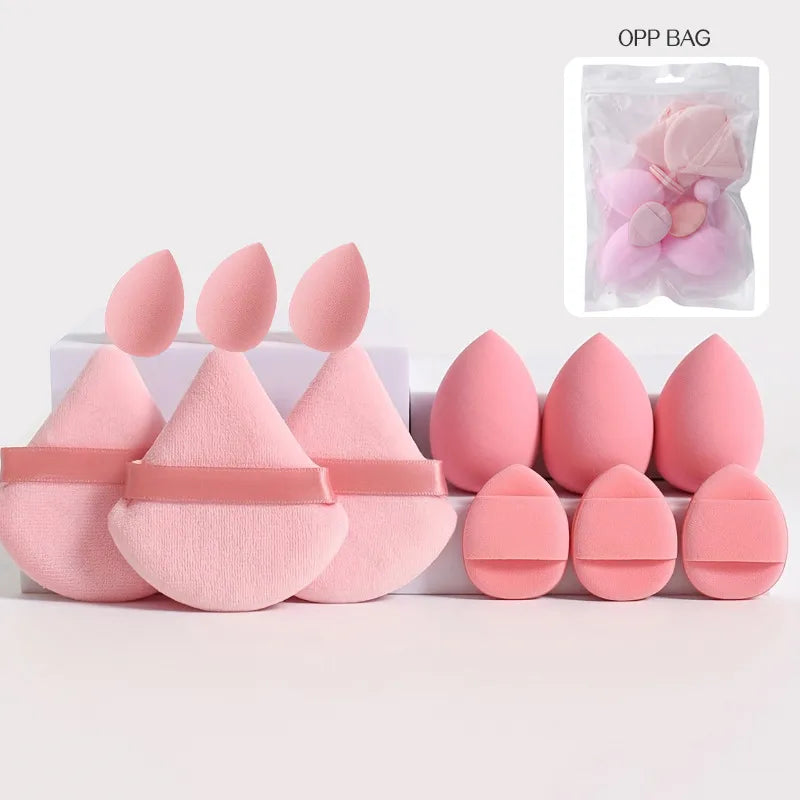 Supplier display of pink sponges and powder puffs; one sponge and one puff per set